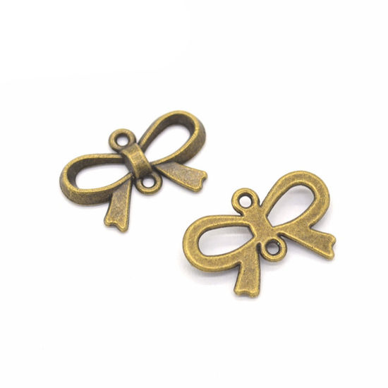 Picture of 50 PCs Zinc Based Alloy Clothes Connectors Charms Pendants Antique Bronze Bowknot Hollow 22mm x 15mm