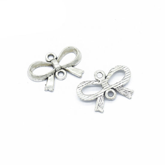 Picture of 50 PCs Zinc Based Alloy Clothes Connectors Charms Pendants Antique Silver Color Bowknot Hollow 22mm x 15mm